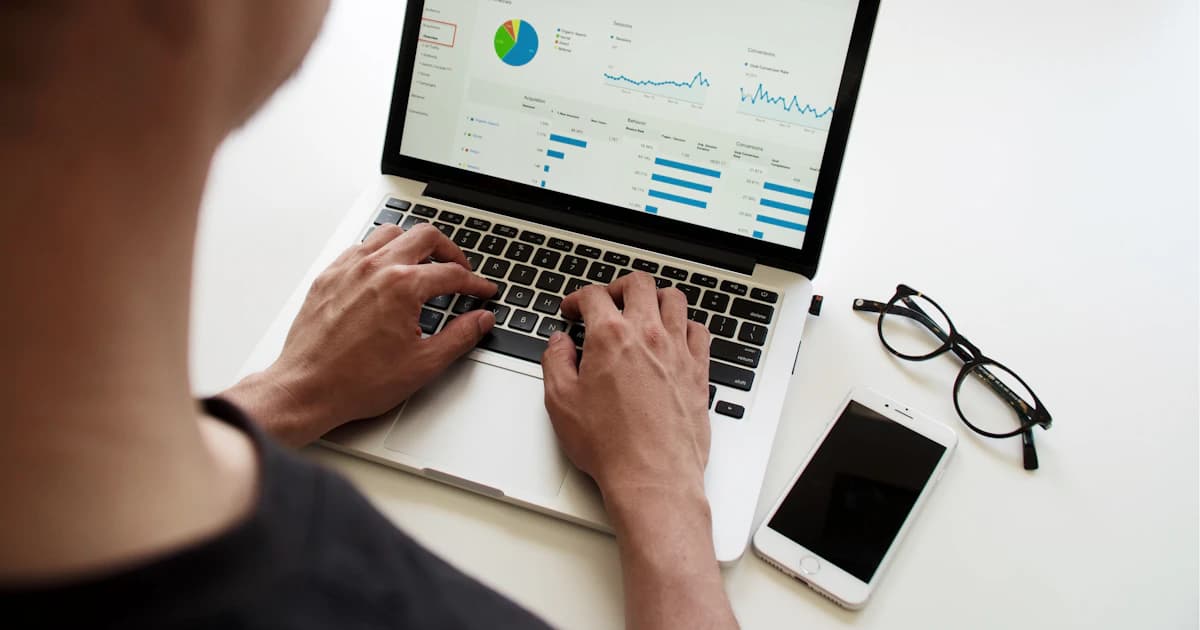 Marketer reviewing website traffic and SEO analytics charts on a laptop
