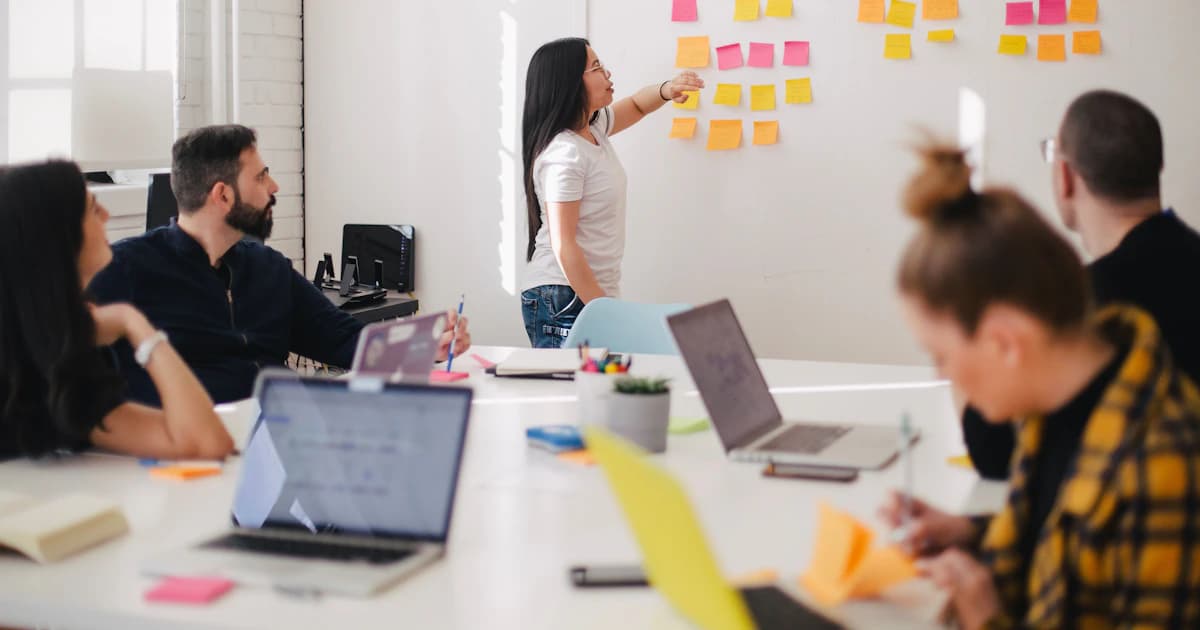 Startup team planning a go-to-market strategy with sticky notes on a whiteboard