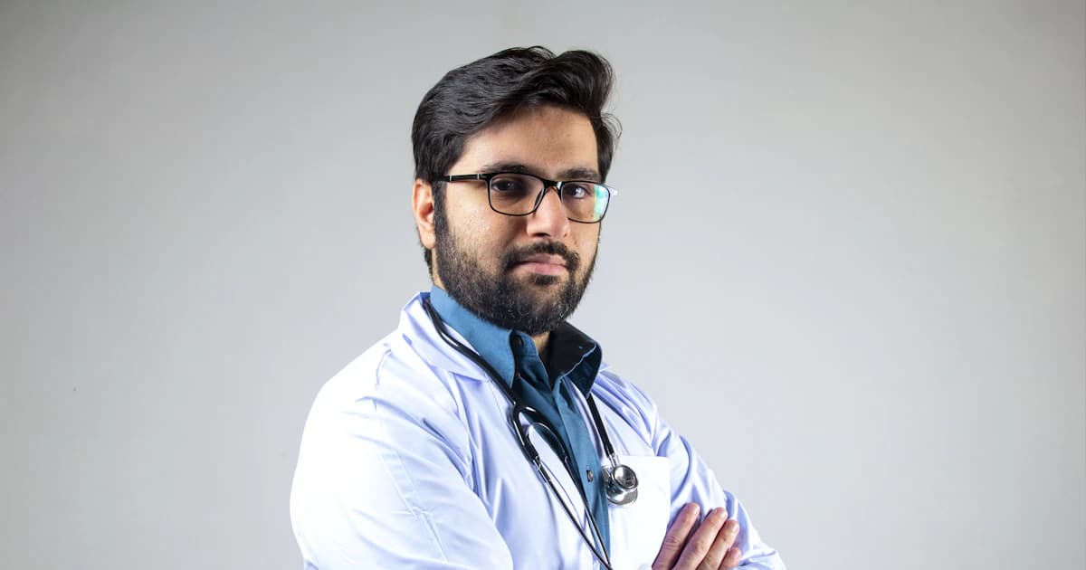 Confident doctor in a white coat with a stethoscope, arms crossed