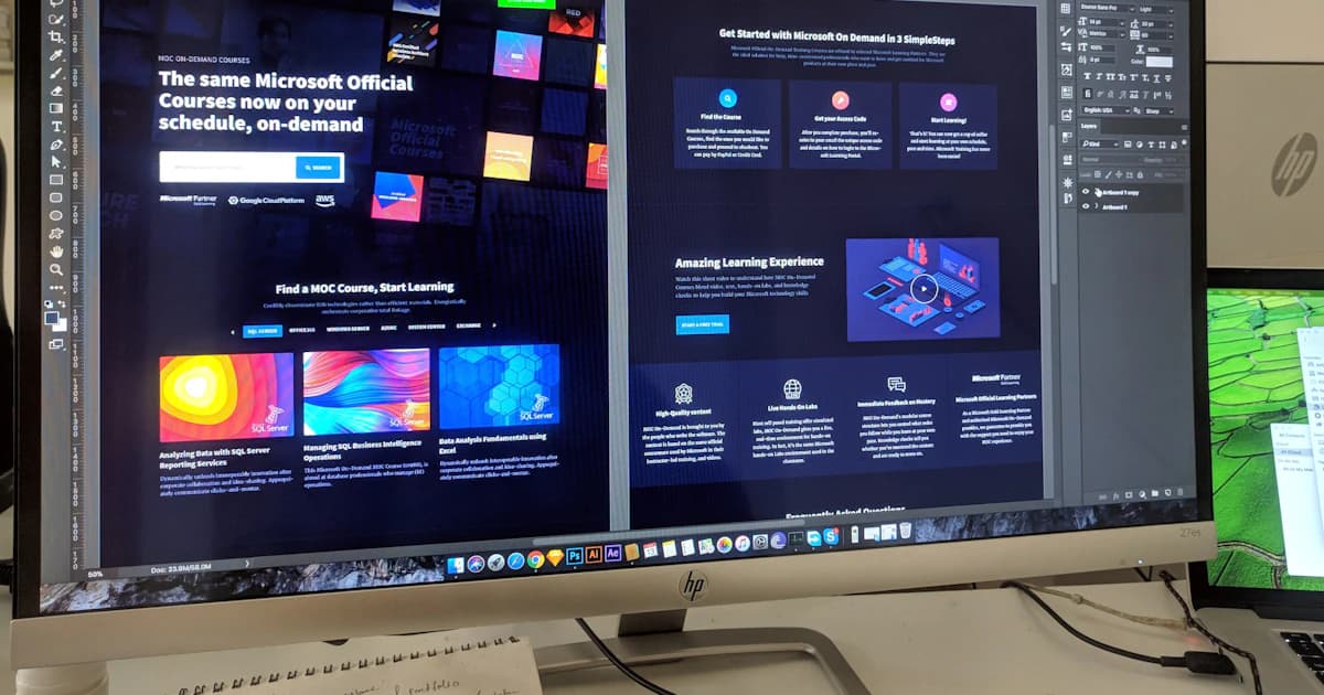 Designer editing a modern website layout on a large desktop monitor